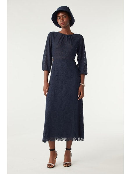Navy midi dress with three quarter length sleeves waist cut outs and open back and scalloped hem with broderie anglais throughout