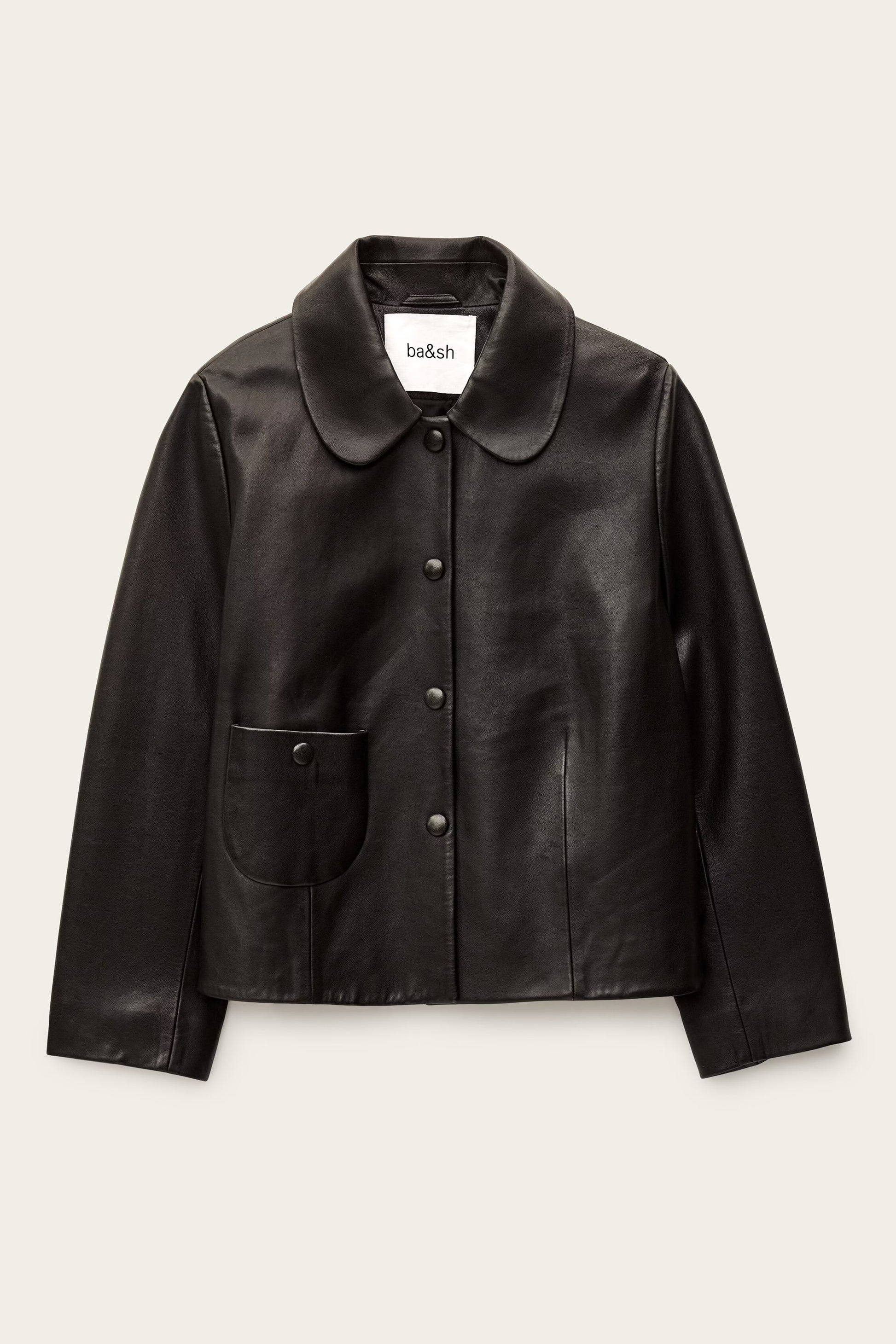 Black leather jacket on a beige background