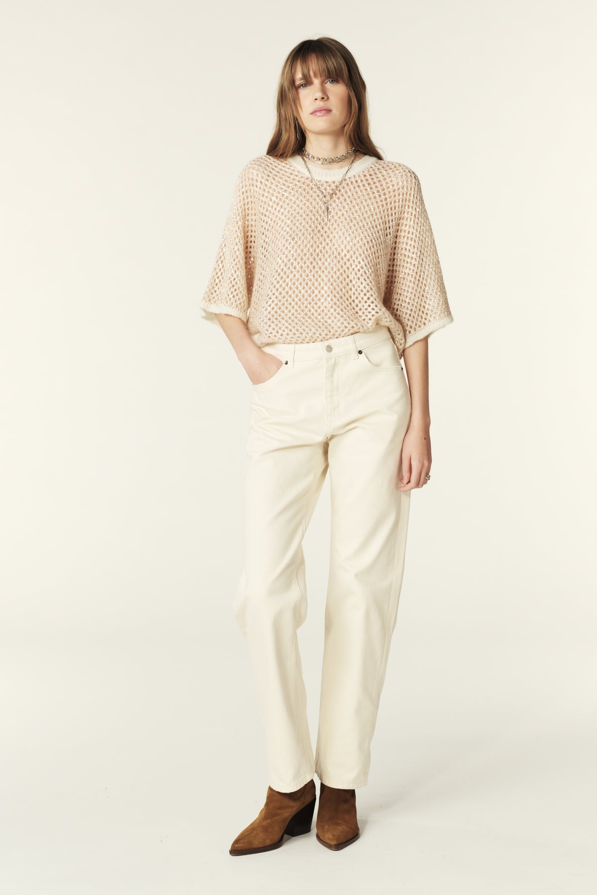 Crew neck open knit in ecru with tiny gold sequin yarn throughout with grown on short sleeves