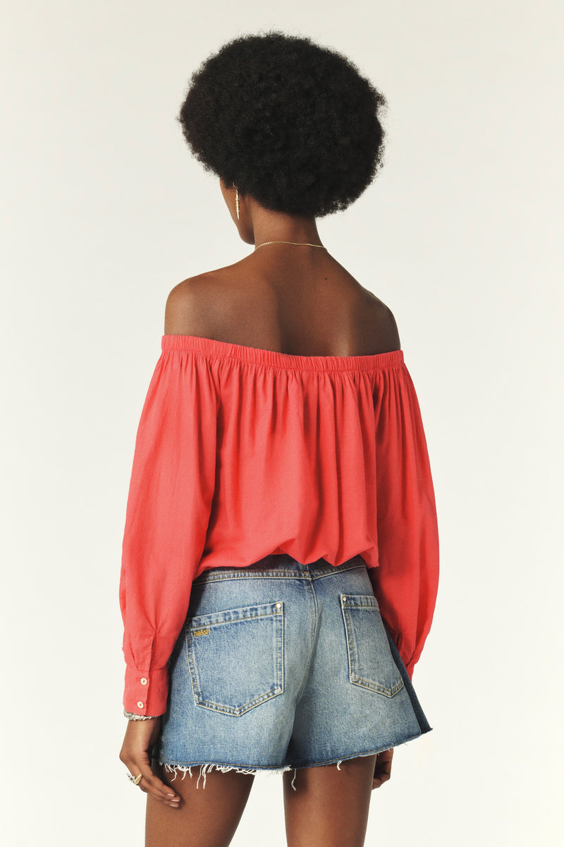 Coral coloured cotton shirt to be worn off the shoulder with a tie front rear view