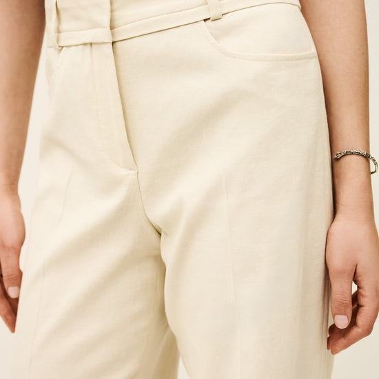 Beige pants worn by a person on a neutral background