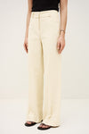 Person wearing cream-colored wide-leg pants on a plain background