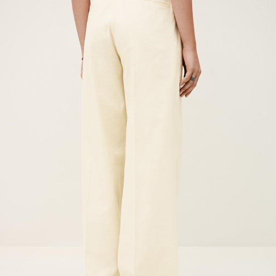 White wide-leg pants worn by a person on a white background