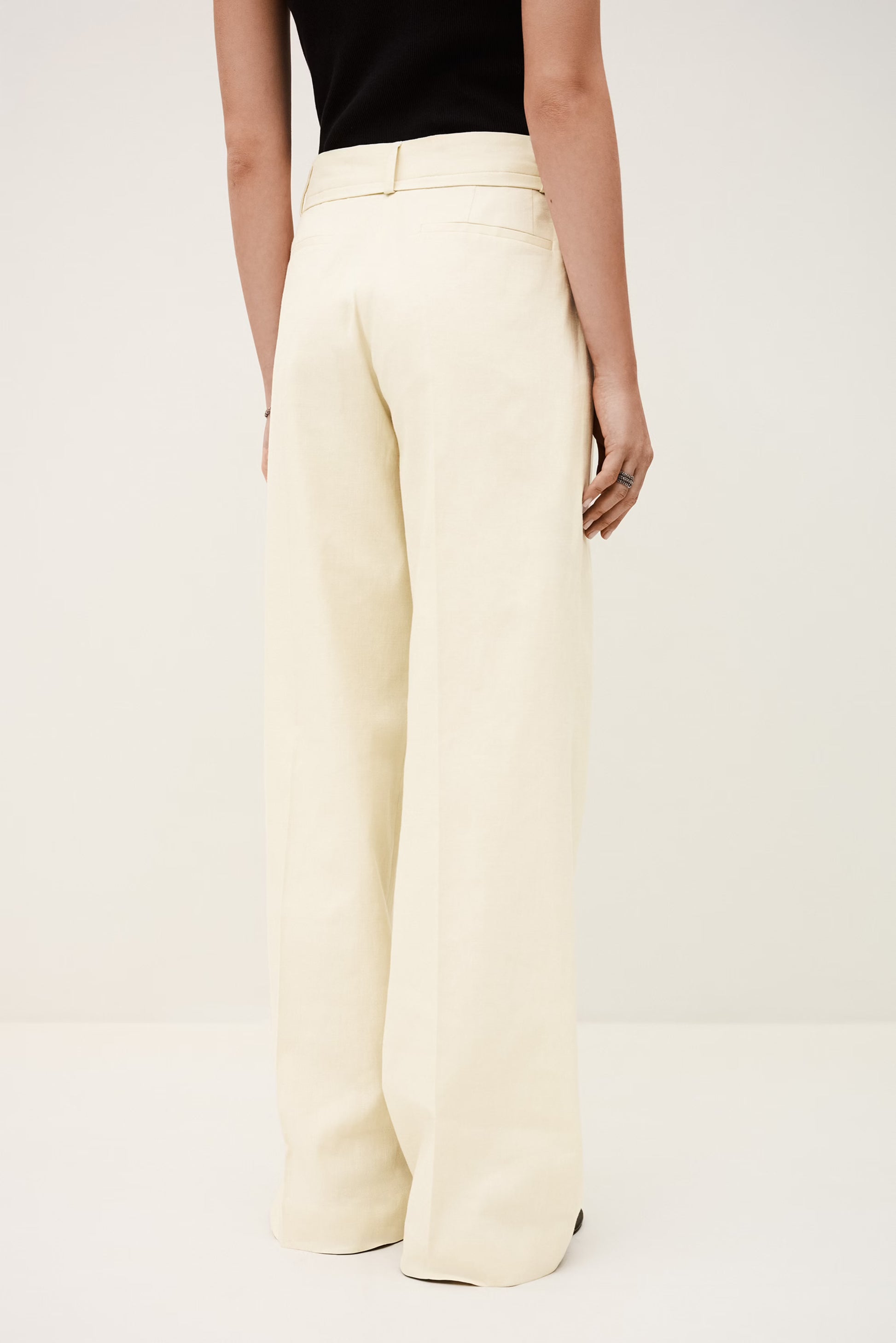 White wide-leg pants worn by a person on a white background