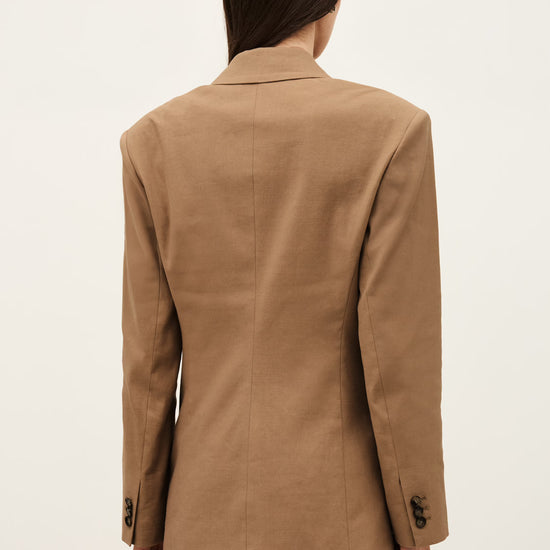 Person wearing a brown suit on a white background from ba&sh