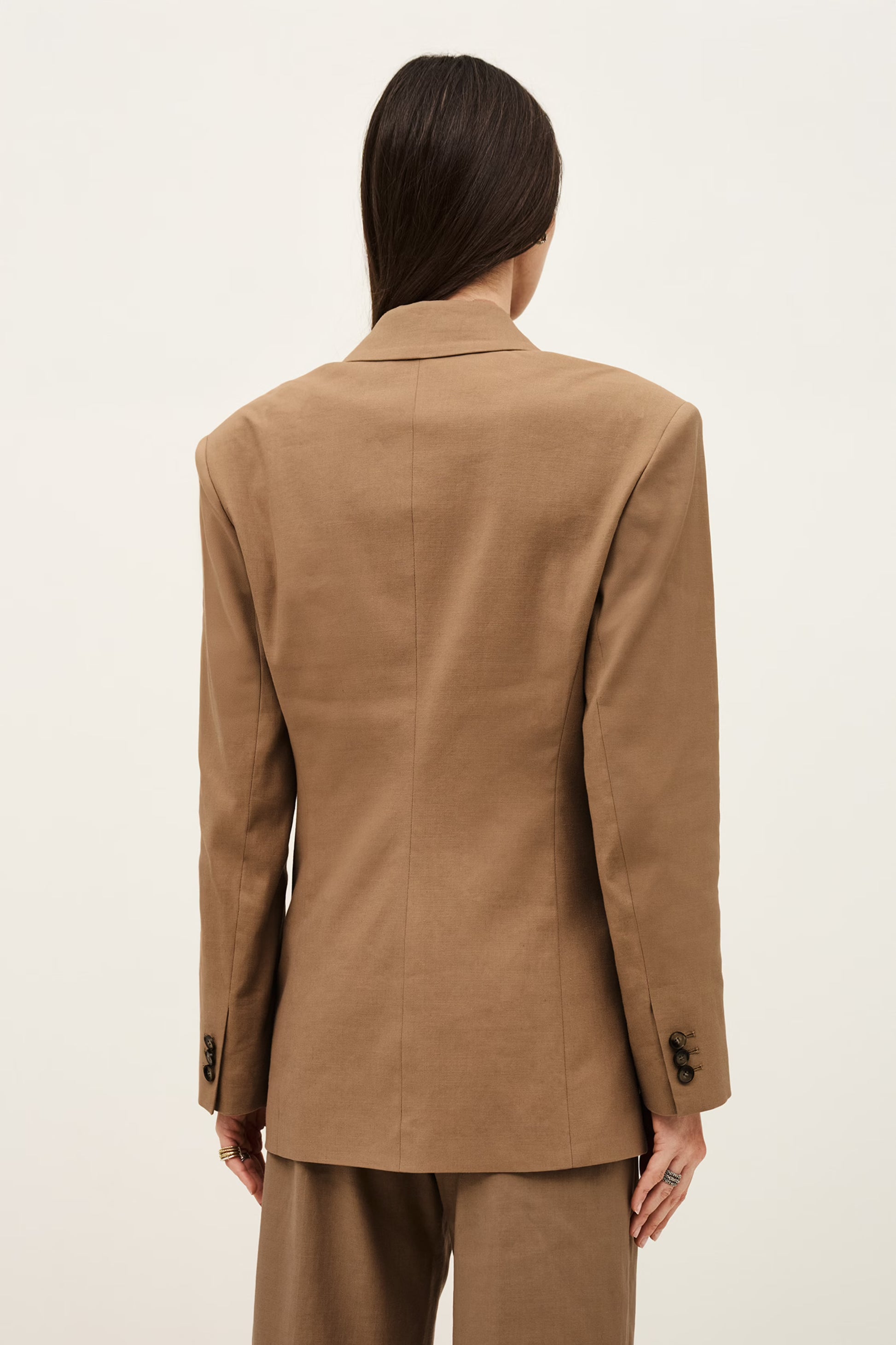 Person wearing a brown suit on a white background from ba&sh