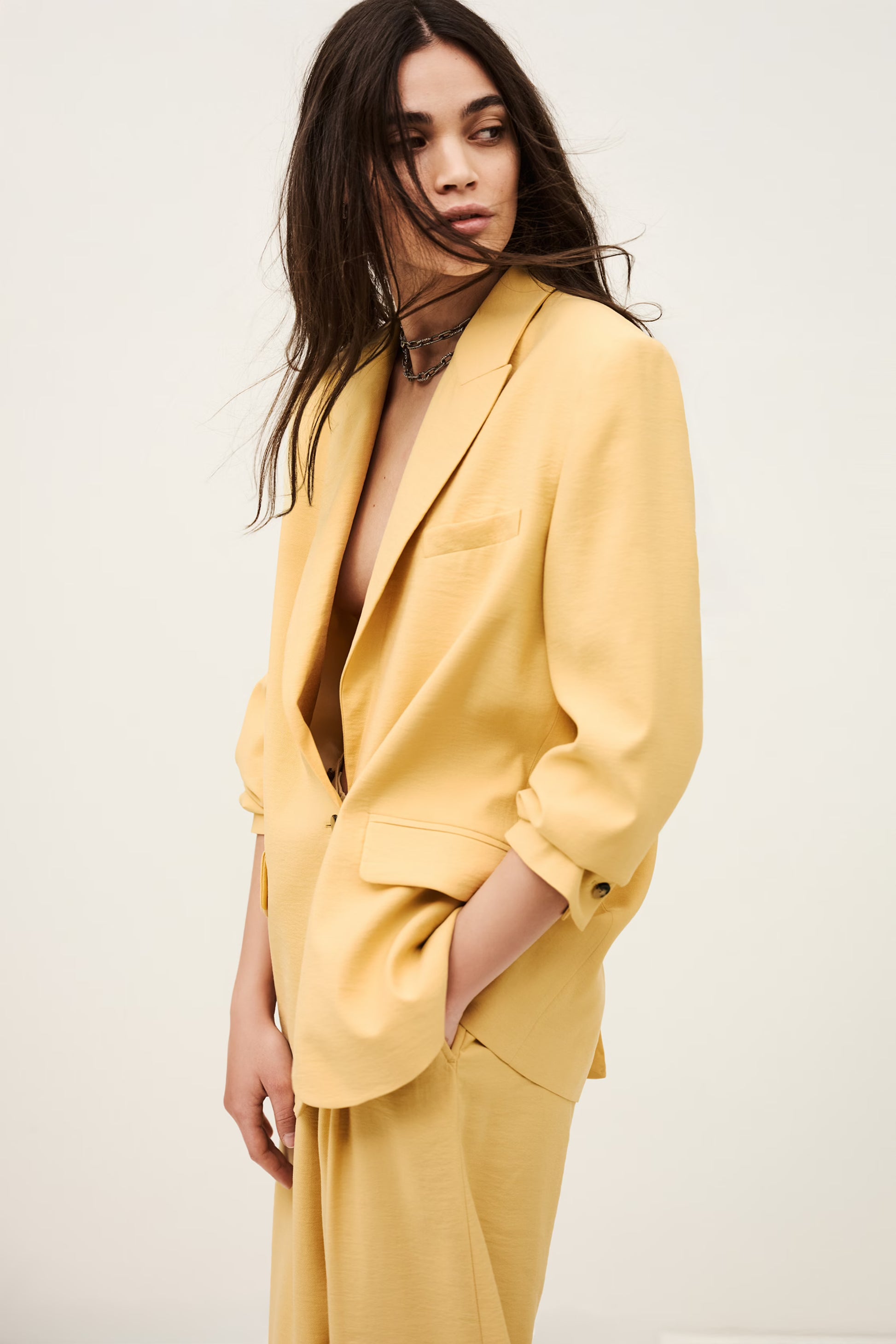 Woman wearing a yellow suit against a plain background from ba&sh