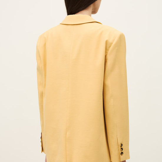 Person wearing a yellow suit against a white background from ba&sh