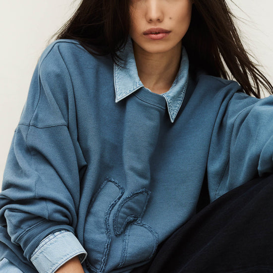 Blue sweatshirt layered over blue shirt
