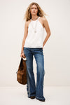 Full model shot of white top with lace inserts worn with denim from ba&sh