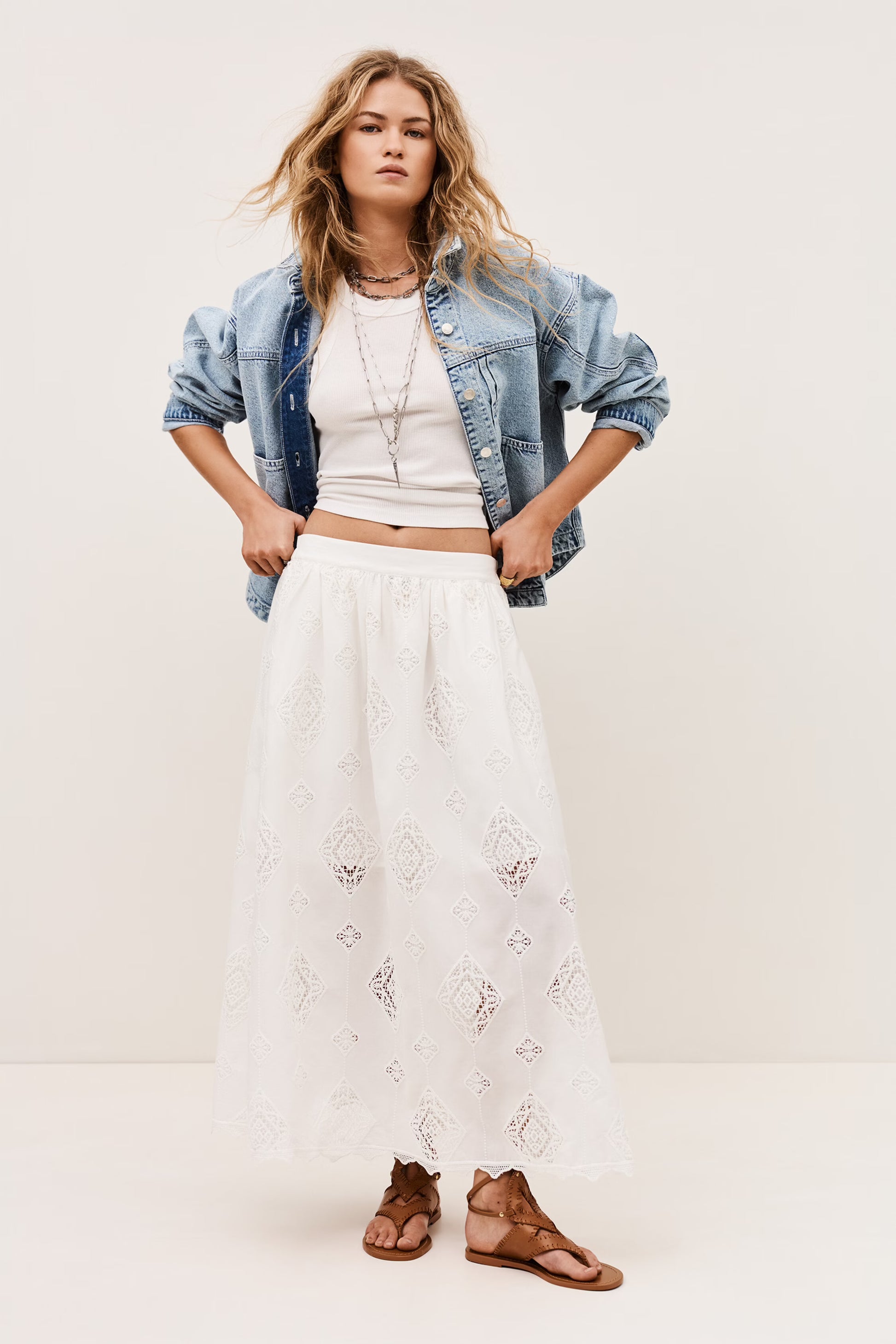 White skirt with lace inserts worn with the matching top and a denim jacket from ba&sh