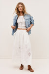 White skirt with lace inserts worn with white vest tee and denim jacket from ba&sh
