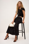 Black skirt with lace inserts and side pockets worn with black tee from ba&sh