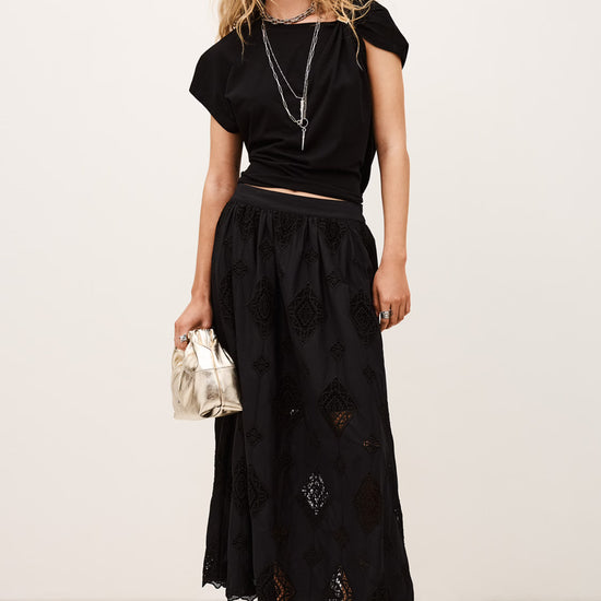 Model shot of black midaxi skirt with lace inserts worn with black tee