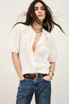 Model wearing white short sleeve shirt with lace inserts from ba&sh