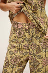 Person wearing a patterned outfit with a neutral background from ba&sh

