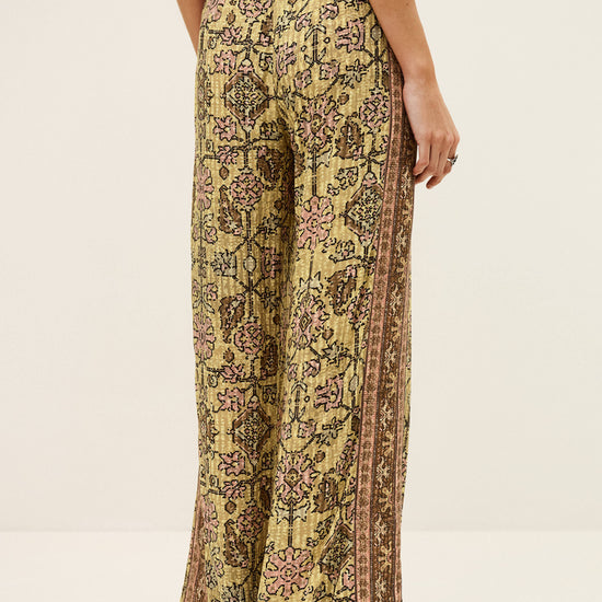Patterned pants worn by a person on a white background from ba&sh