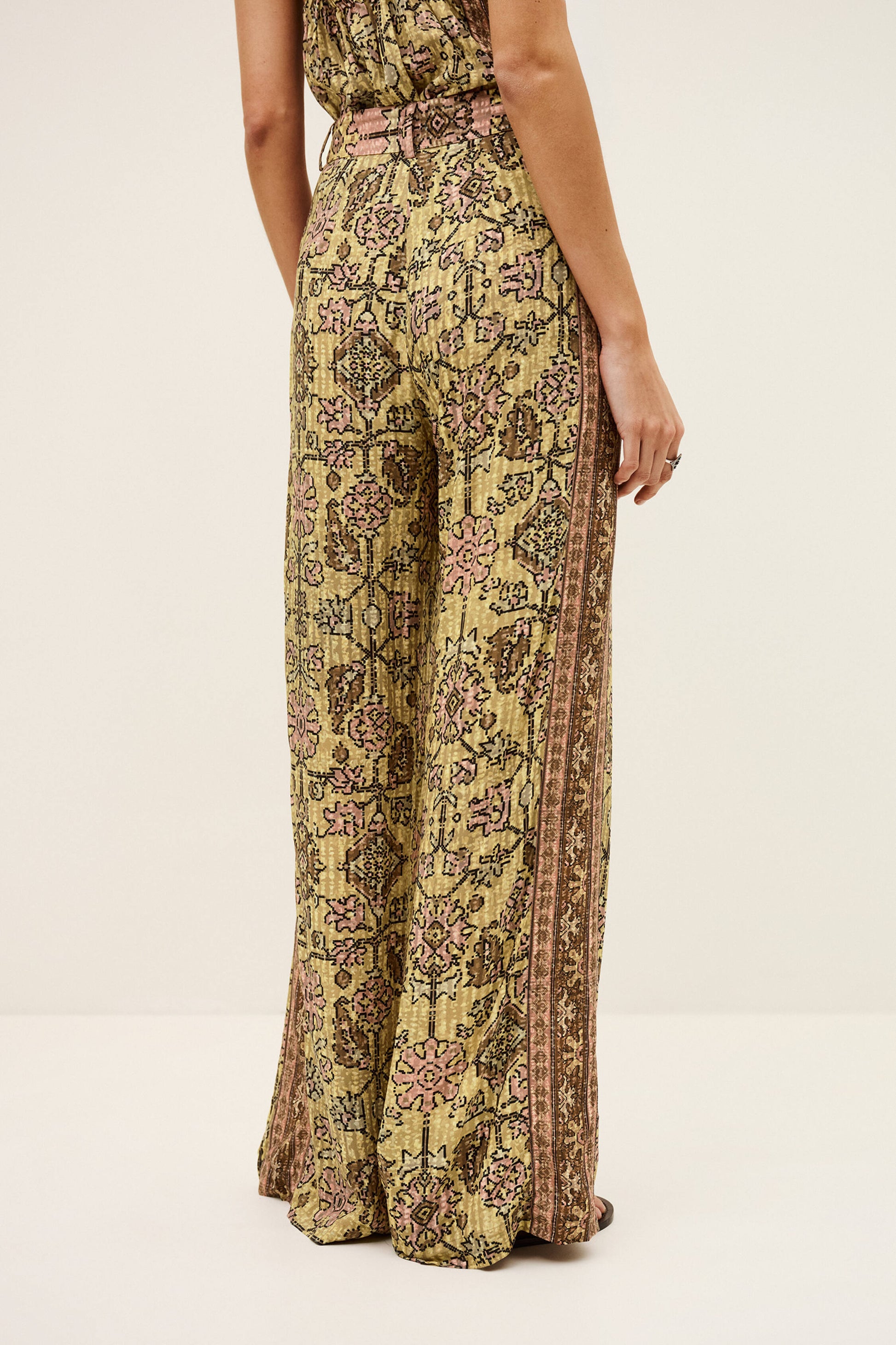 Patterned pants worn by a person on a white background from ba&sh