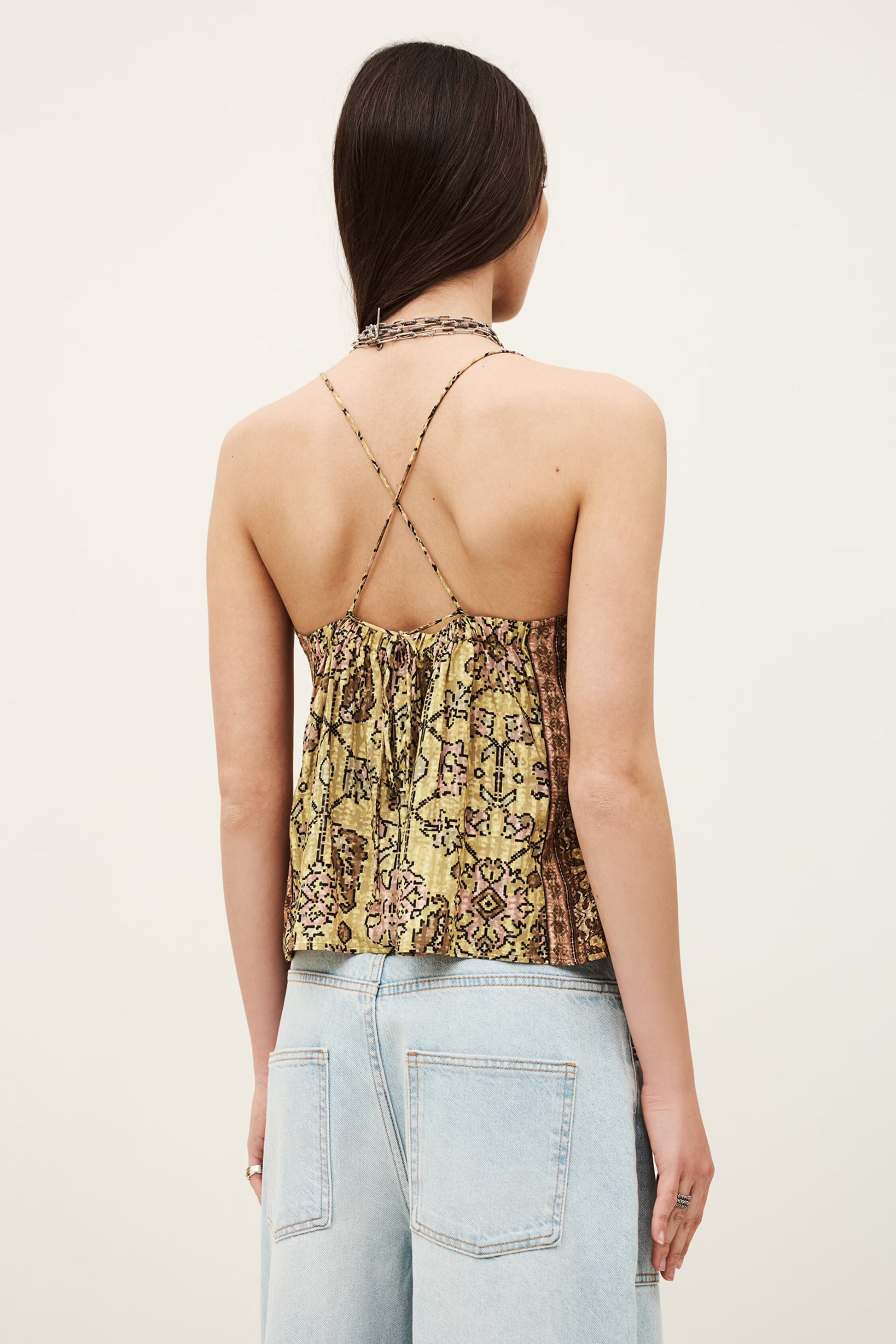 Rear view of yellow top with cross strap back