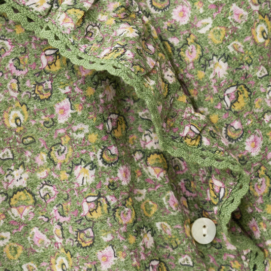 Close-up of a green floral patterned fabric with a button from ba&sh