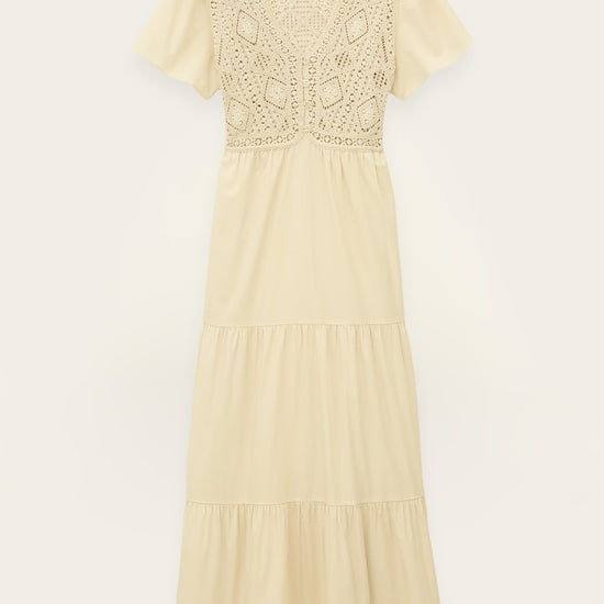Beige dress with lace detailing on a white background