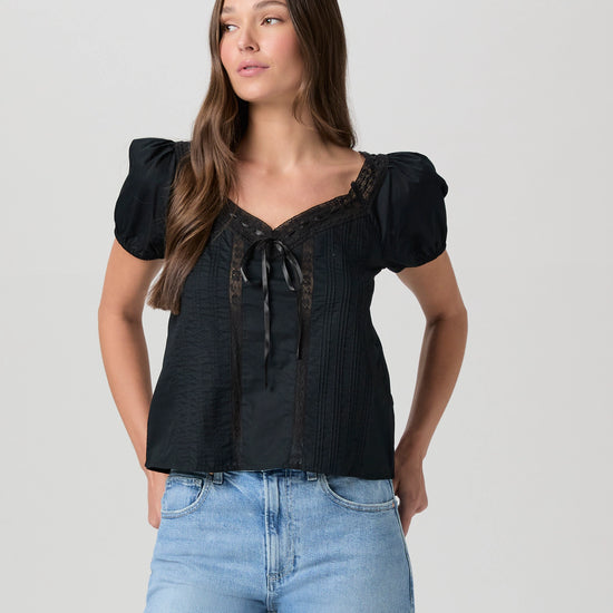 black cotton top with short sleeves, lace detailing and tie at the bust