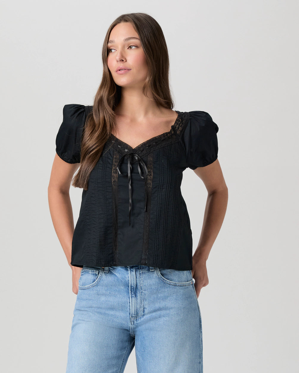 black cotton top with short sleeves, lace detailing and tie at the bust
