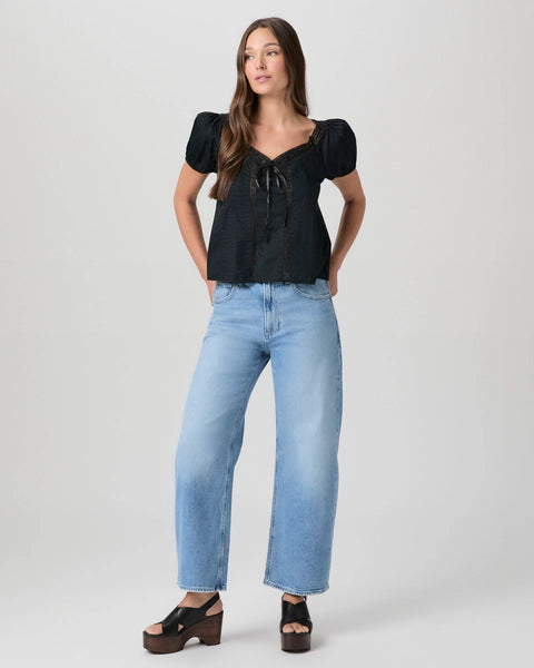 black cotton top with short sleeves, lace detailing and tie at the bust model shot