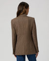 Rear view of brown dog tooth blazer worn with blue jeans