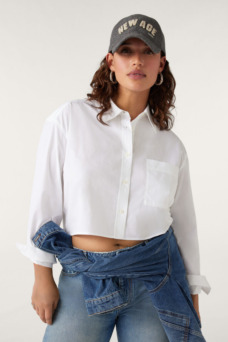 Cropped white shirt with single front patch pocket classic collar and long sleeves