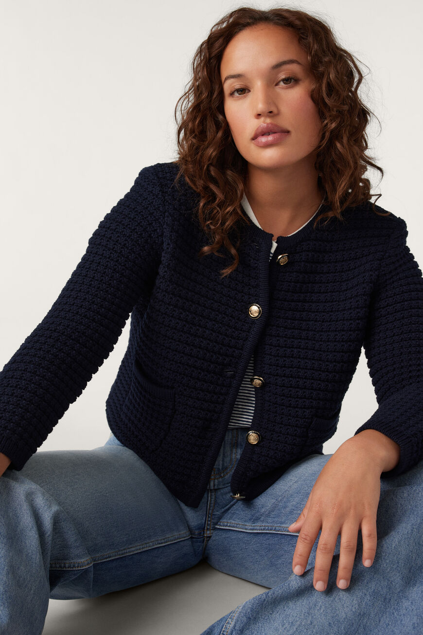 Navy blue round neck textured cardigan with two front pockets and fancy buttons
