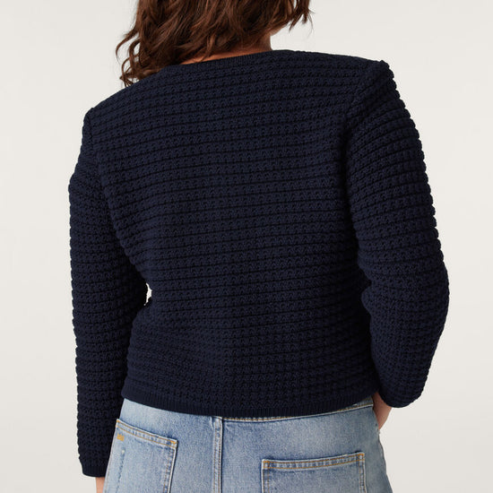 Navy blue round neck textured cardigan with two front pockets and fancy buttons