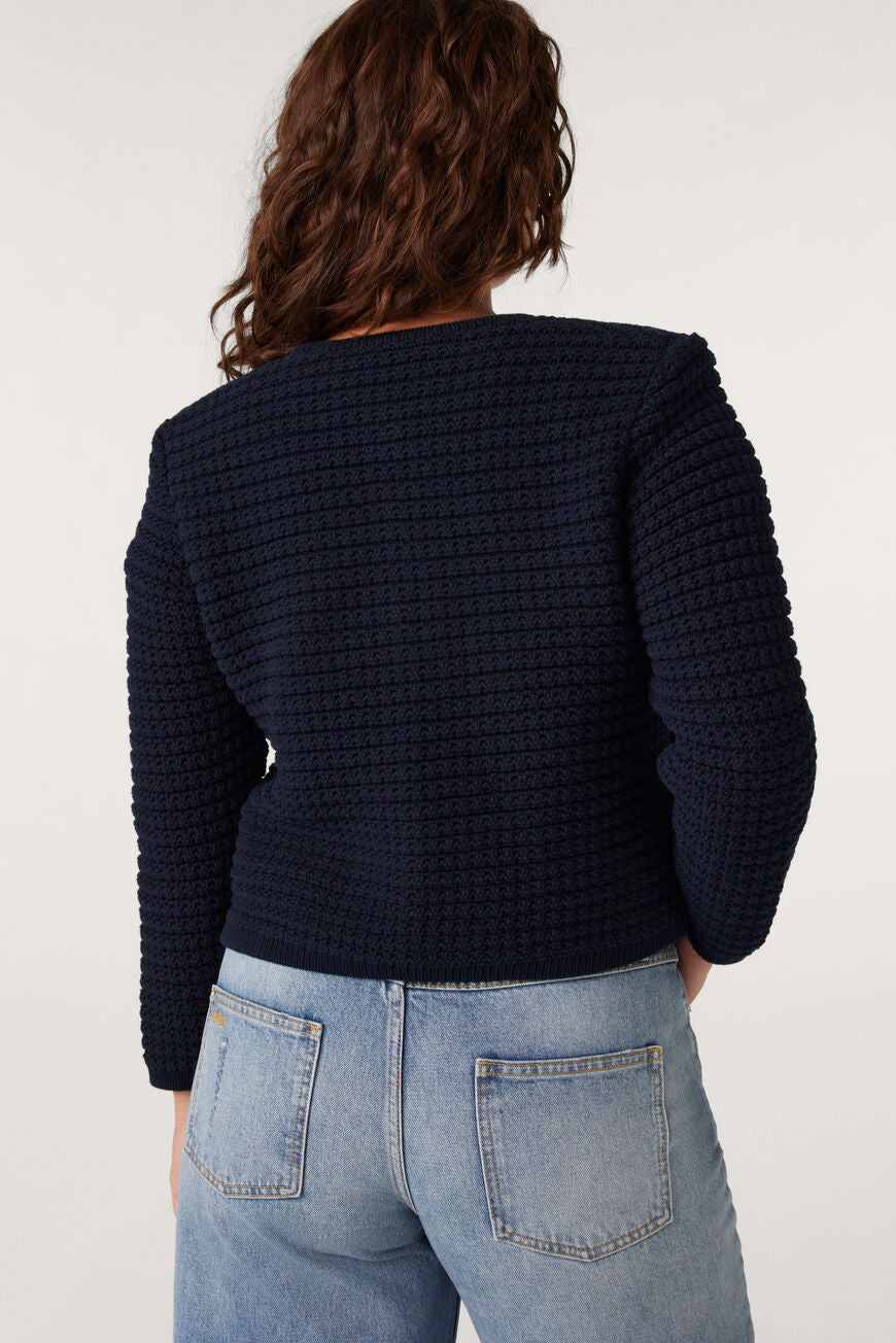 Navy blue round neck textured cardigan with two front pockets and fancy buttons