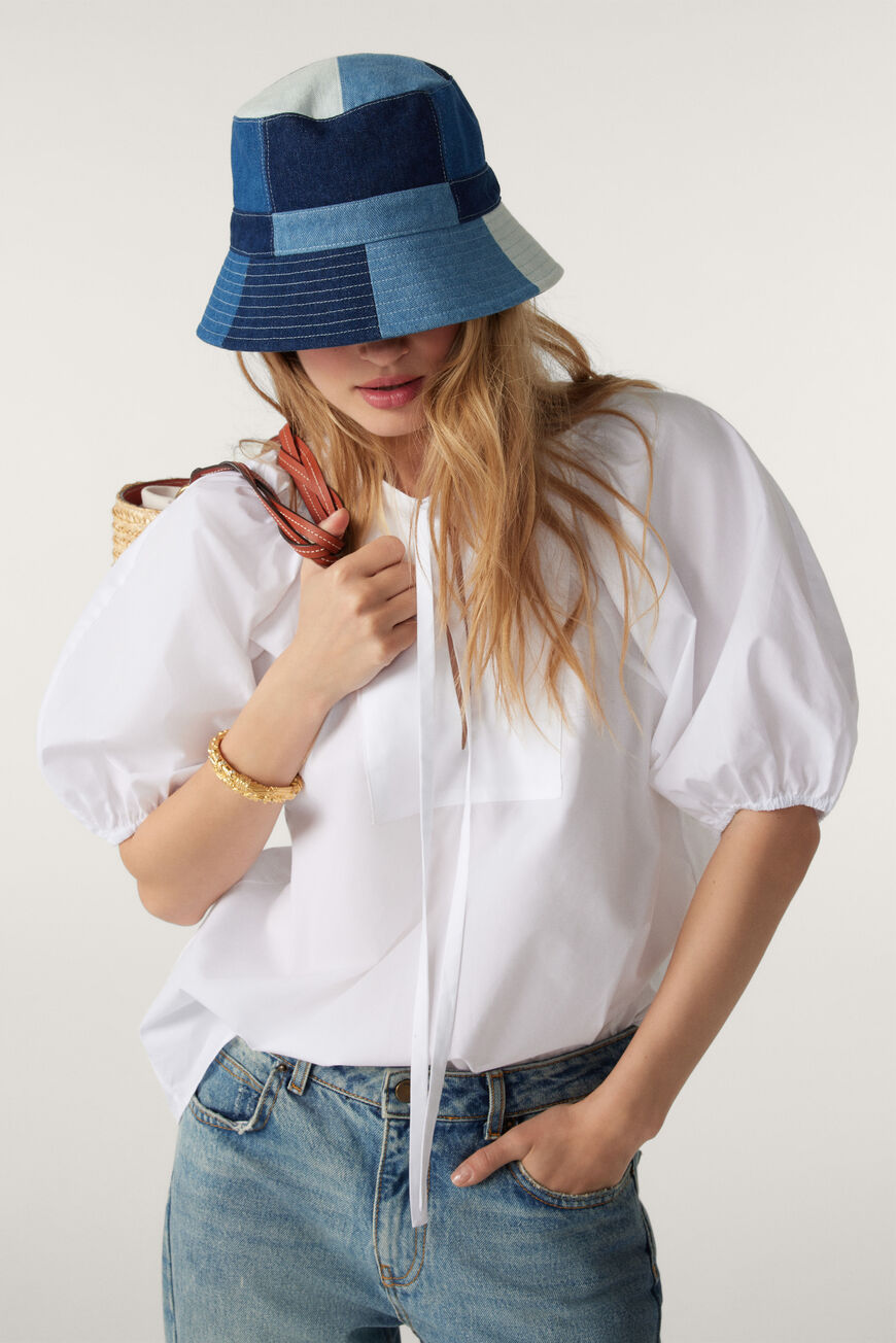 White short sleeved smock top with neck tie and gathering at yoke and around nape of neck