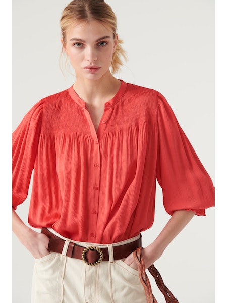 Collarless shirt with long sleeves and shirred panels across the shoulder and at the cuff