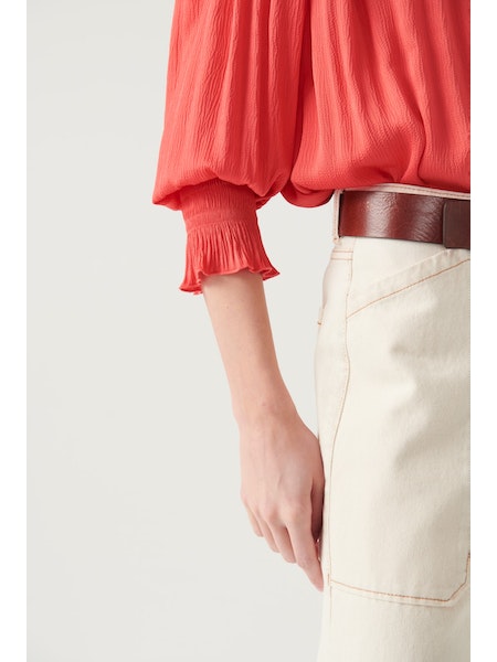 Collarless shirt with long sleeves and shirred panels across the shoulder and at the cuff