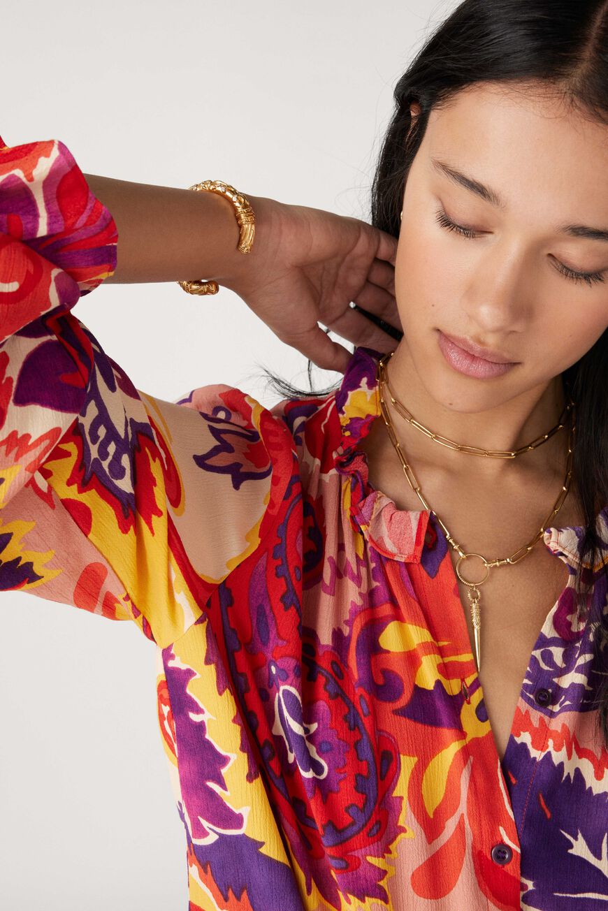 Button through blouse with long sleeves ruffle collar in a vibrant paisley inspired orange yellow and purple print