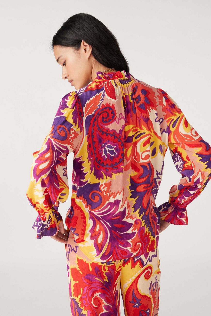 Button through blouse with long sleeves ruffle collar in a vibrant paisley inspired orange yellow and purple print