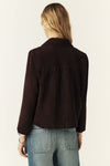 Brown jacket worn by a person on a plain background