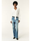 Model shot of ecru blouse with removable neck tie worn with blue jeans