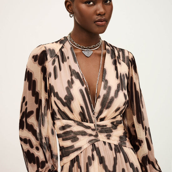 Woman wearing a leopard print dress with a plain background