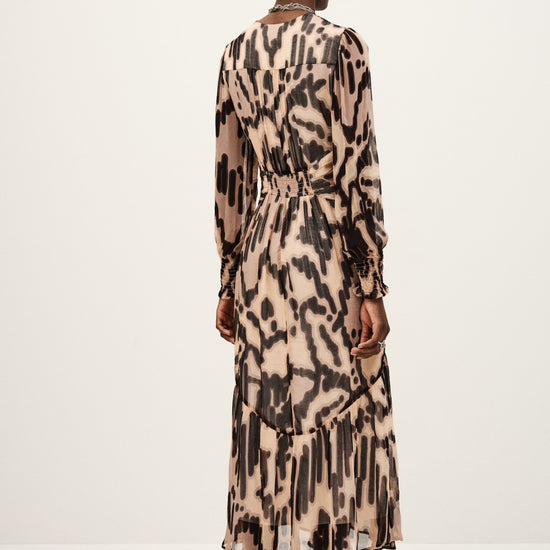 rear view of person wearing a long-sleeve, leopard print dress on a white background