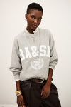 Person wearing a gray sweatshirt with 'BA&SI' branding on a white background
