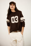 brown cashmere round neck sweater with 03 on front model shot