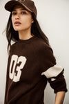brown cashmere round neck sweater with 03 on front model shot