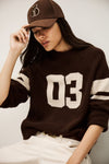 brown cashmere round neck sweater with 03 on front model shot