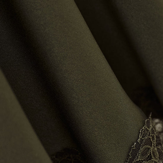 Close-up of dark green fabric with lace detailing from ba&sh