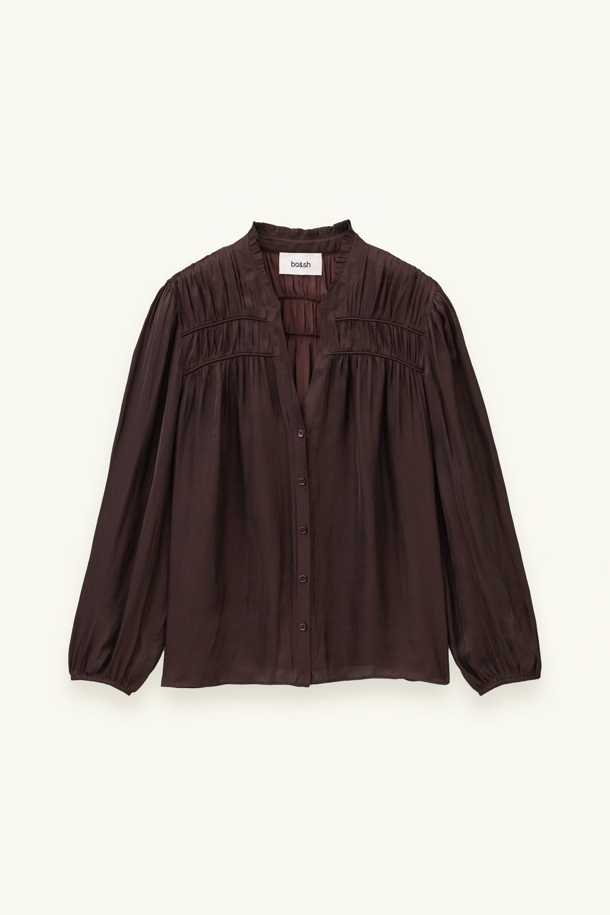 A dark brown long-sleeve blouse with a gathered, smocked bodice and button-front closure, displayed flat against a light cream background.