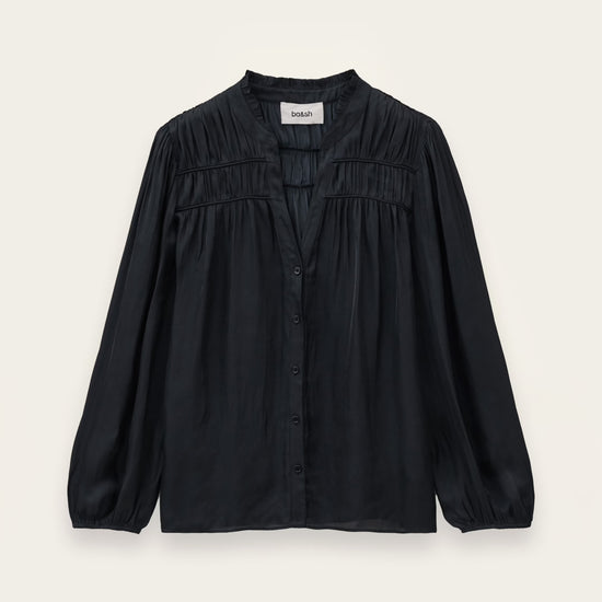 A black long-sleeve blouse with a gathered, pleated chest design and a button-down front, displayed flat against a light cream background.