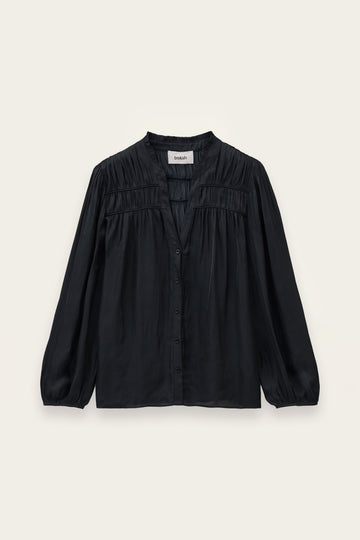A black long-sleeve blouse with a gathered, pleated chest design and a button-down front, displayed flat against a light cream background.